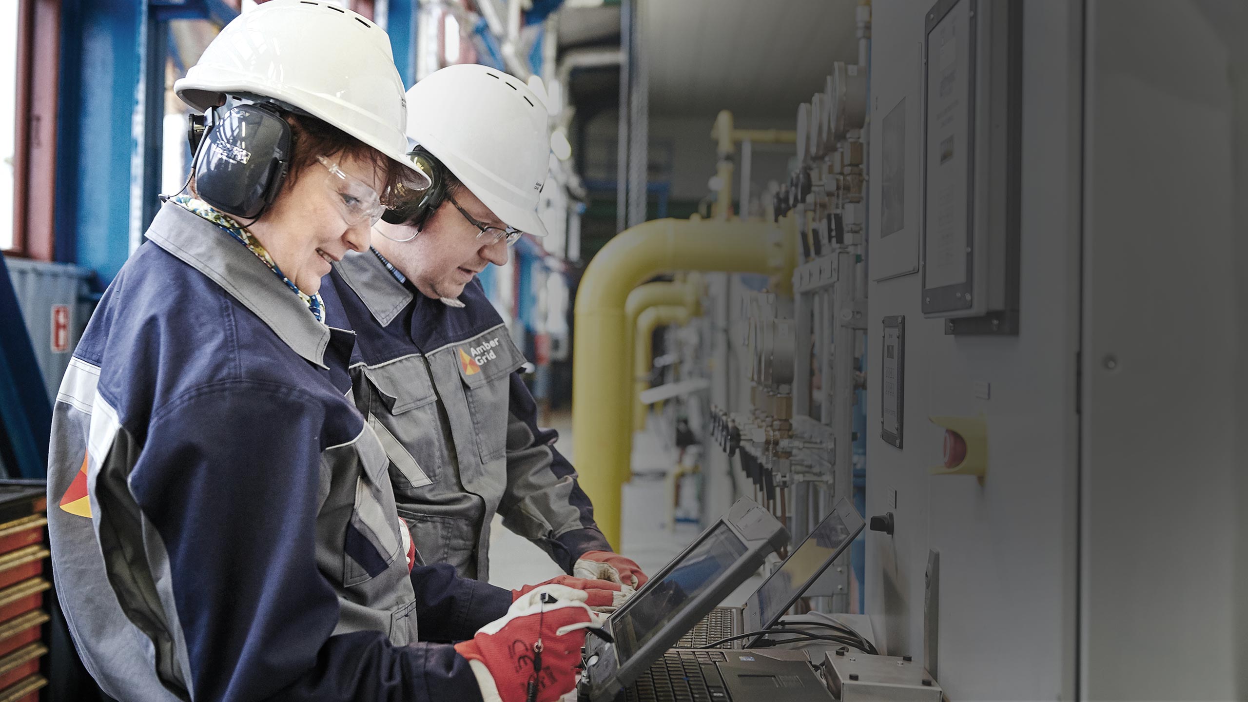 two persons at a control panel two persons at a control panel